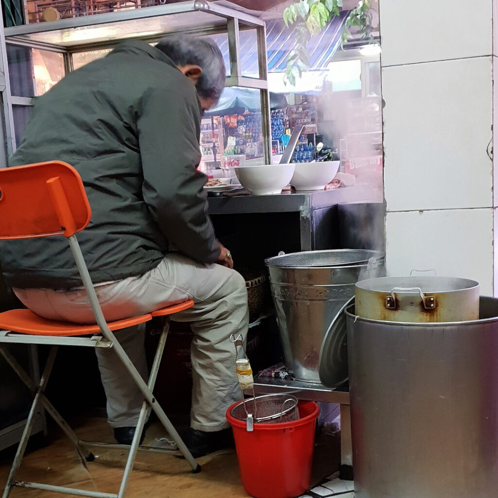 Preparing a bowl of pho