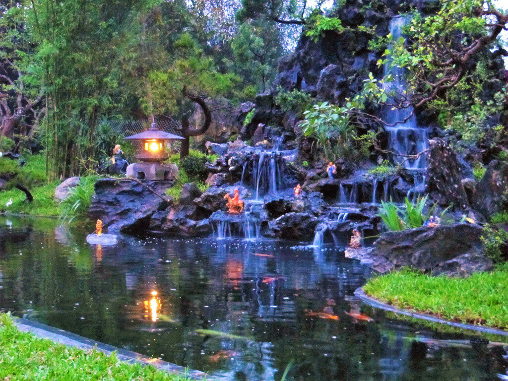 Garden with pond and fish swimming