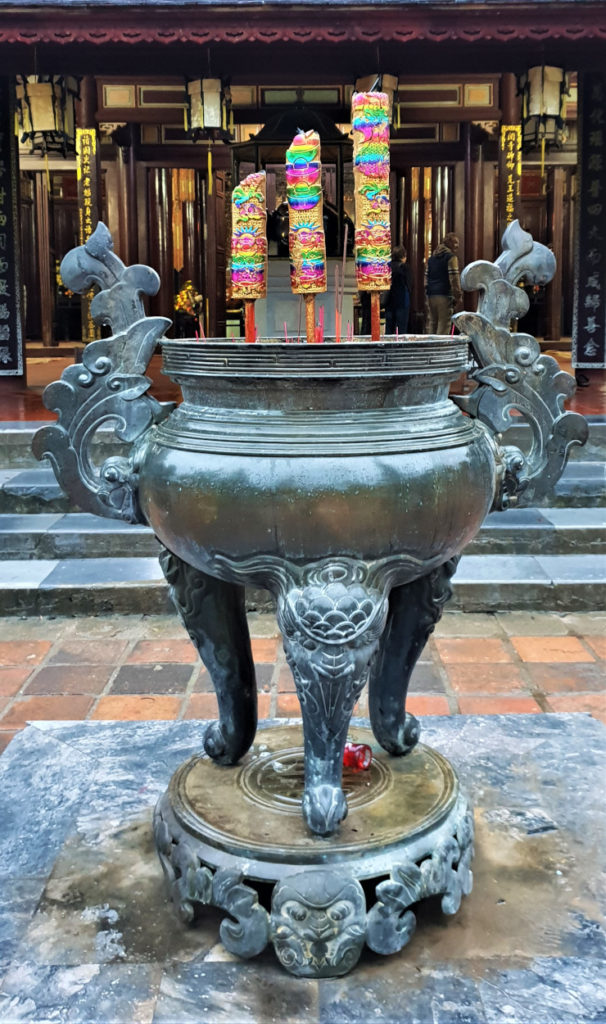 Urn with incense sticks in front of Dai Hung grand temple