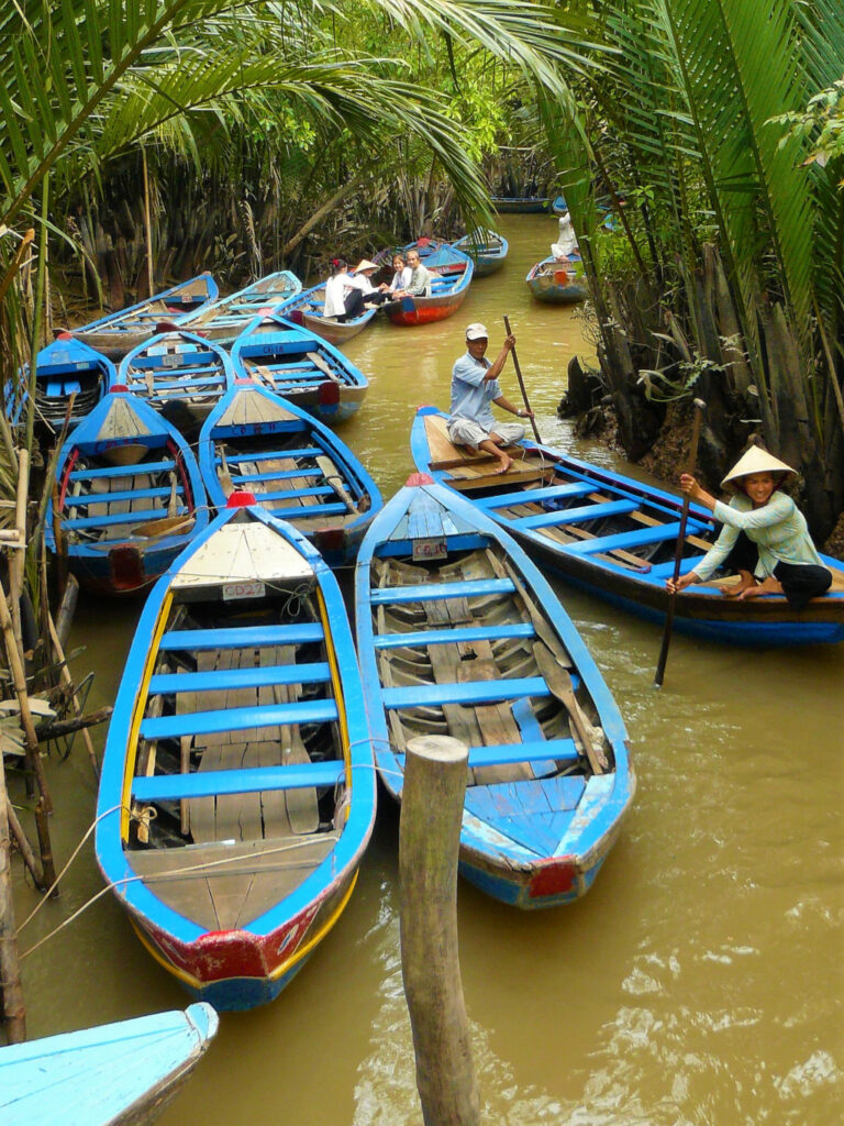 Sampans weaving their way past each other on the narrow canals in the Mekong Delta