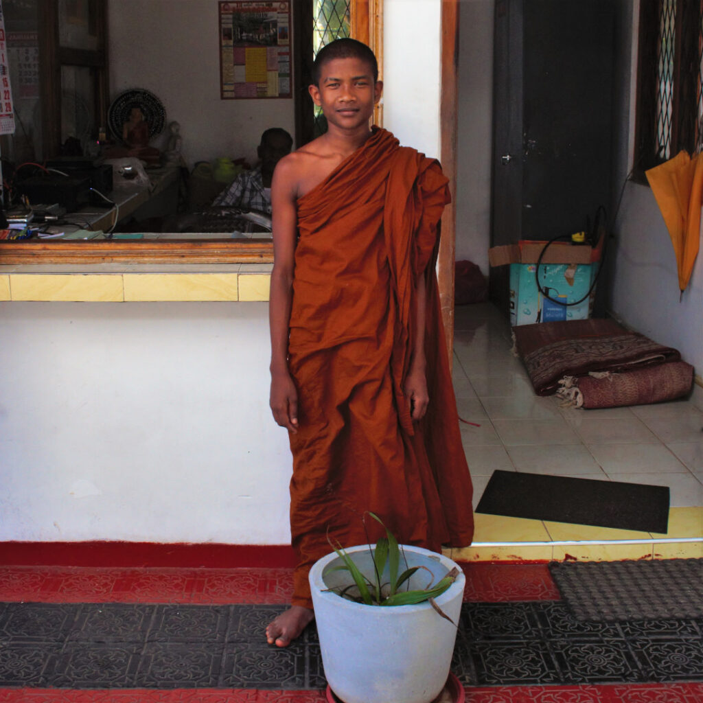 A young monk honours me with a smile for the camera