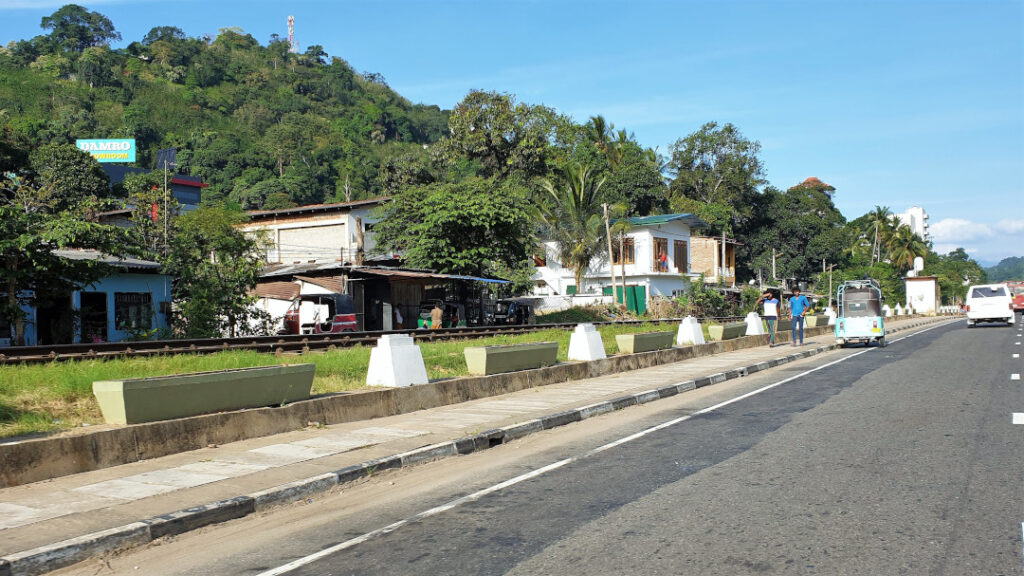 The train line running parallel to the highway