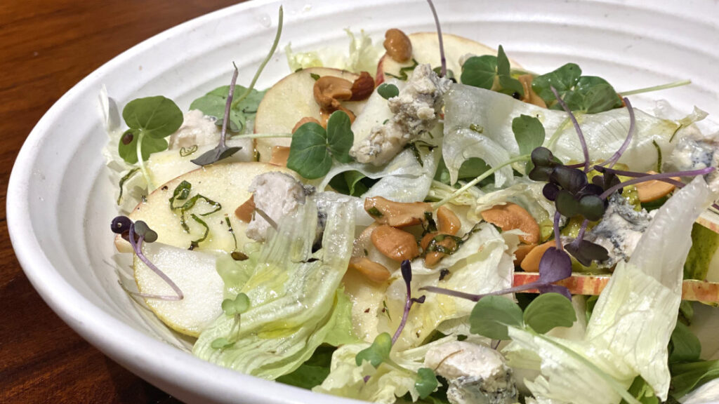 Pear cashew spinach salad with baby spinach, pears, apples with toasted cashew, dried cranberry, and gorgonzola cheese dressed with honey basil vinaigrette