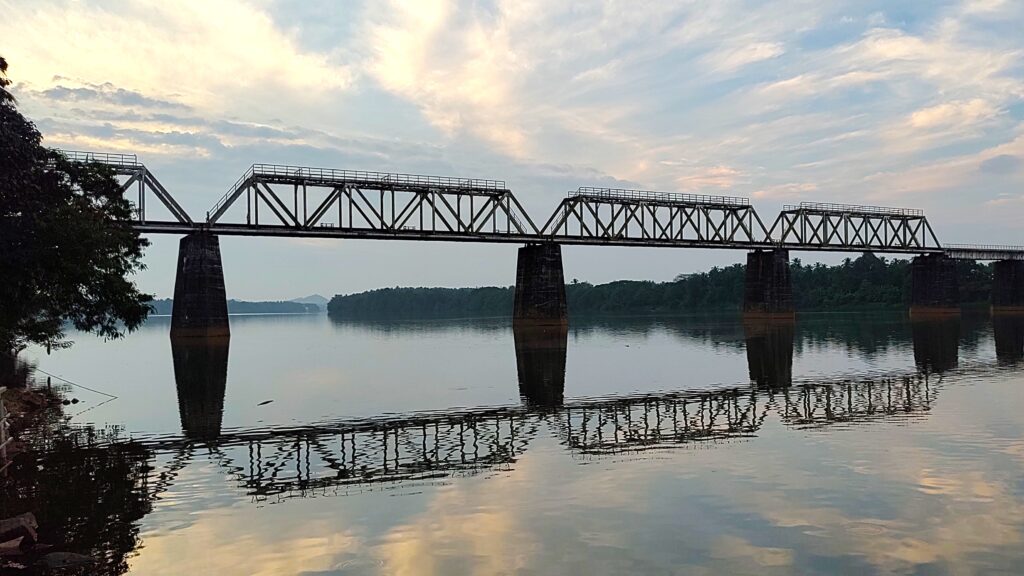 The railway bridge across the Netravati River, viewed from the temple complex.